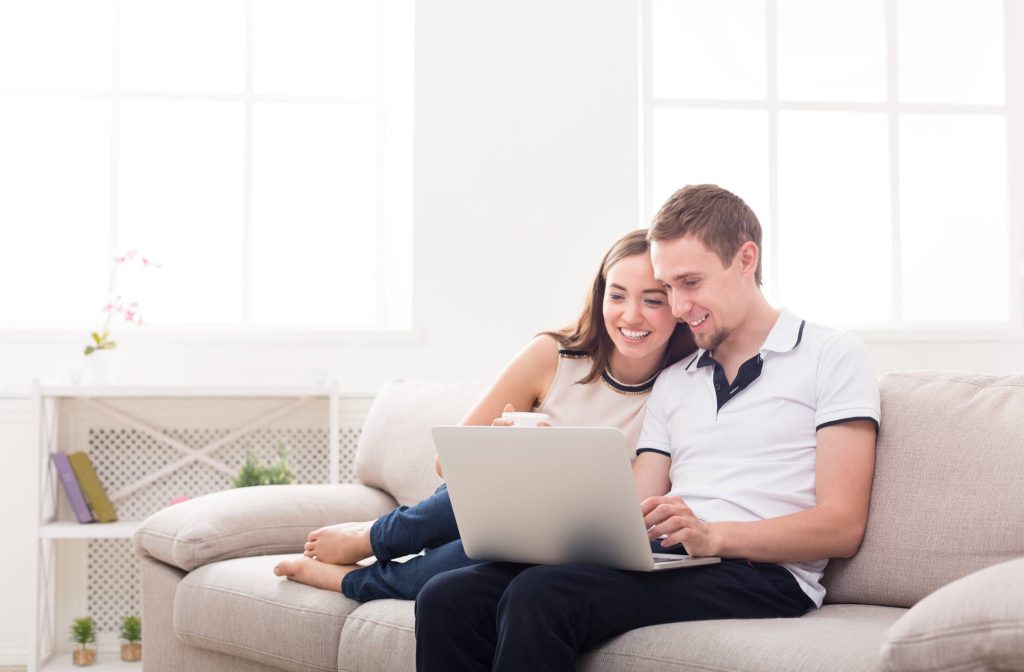woman and man looking at laptop