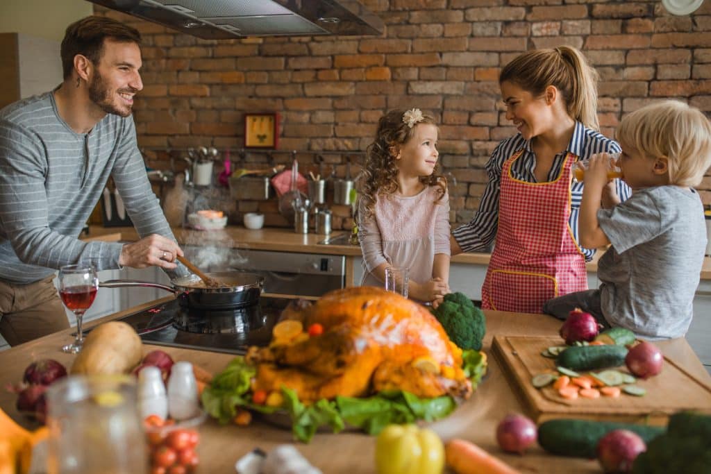 family of four around kitchen counter